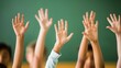 © Khalis Mustapha - Students raising hands in classroom for participation and engagement-focused educational concepts.