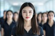 © Alexandr - A side view of call center employees in a line, featuring a focused and smiling Korean girl amidst her colleagues and manager