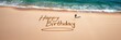 © meatandgrill - Person writing happy birthday on sandy beach during daytime with waves lapping at shore