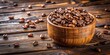 © Nasnunt - Wooden cup filled with freshly roasted coffee beans on a rustic wooden table , roast, beans