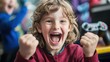 © Tanyarat - A joyful child celebrates a gaming victory, expressing excitement with raised fists and a big smile.