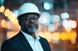 © Сергей Захаров - confident 45-year-old black project manager wearing business suit and hard hat standing in front of construction progress