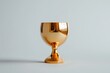 © adri - Golden goblet on gray background.