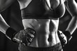 © Roshani - Strong woman showcasing fit body in black and white photo.