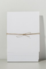 Wall Mural - stack of blank easter cards tied together with twine resting on neutral white surface with minimalist style