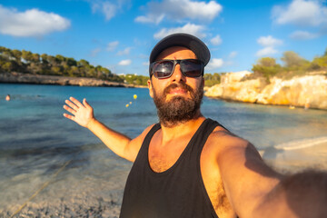 Wall Mural - Tourist taking a selfie on s'amarador beach in mallorca