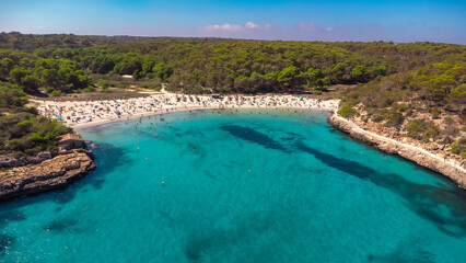 Wall Mural - Tourists relaxing on the beach of cala s'amarador and cala mondrago in mallorca, spain