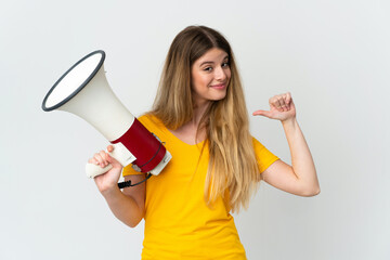 Young blonde woman isolated on white background holding a megaphone and proud and self-satisfied