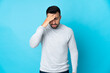 © luismolinero - Caucasian man over isolated blue background with headache