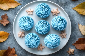 Wall Mural - Delicious blue marshmallows zephyr forming a circle on white plate with autumn leaves decoration