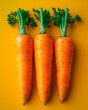© Kaio - A photo of three carrots with an orange background