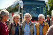 © miss irine - Group of happy senior tour participants stands in front of tour bus. They are smiling and seem to be enjoying their journey. Outdoors activity and lifestyle concept is shown in the photo.