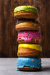 © freeman83 - Colorful donuts on wooden background.