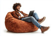 © Aleksandr Matveev - A man is sitting on a bean bag chair and using a laptop. He is smiling and he is enjoying himself. Concept of relaxation and leisure
