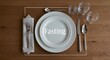 © Loki Studio - Elegant dinner table setting for fasting representation with decorative plate and utensil, fasting text, napkin, and cutlery on wooden surface