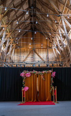 Wall Mural - Black wall in a larg barn with a flower decorated opening.