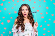 © deagreez - Close up portrait of shocked face brunette woman with wide open mouth, big eyes and fake mustache on stick in hands isolated on bright turquoise background