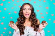 © deagreez - Close up portrait of beautiful, attractive, pretty, dreamy, charming curly lady people, person look aside hold muffins in hands isolated on shine teal background