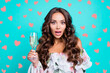 © deagreez - Close up portrait of brunette lady with glass of alcohol in hands look at camera with wide open mouth and big eyes isolated on vivid teal background