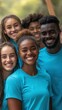 © BrightWhite - Smiling diverse group of young volunteers wearing blue shirts