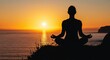 © Kenny - A silhouette of a person meditating on a cliff overlooking the ocean at sunset