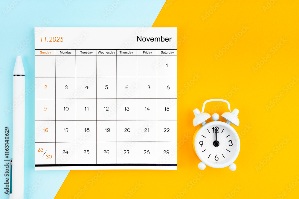 November 2025 Monthly calendar for 2025 year with pen on yellow and ...