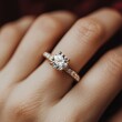© Lui Shtein - Elegant diamond engagement ring on female hand with rose gold band