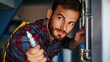 © Maftuh - Focused Plumber Inspecting Pipes:  A Close-Up of a Dedicated Professional at Work Examining Plumbing System