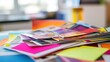 © andyaziz6 - A Colorful Stack of Printed Materials on a Desk