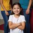 © Pixel Matrix - Young Hispanic girl in t-shirt  jeans braces smile at family function arms crossed looking at camera