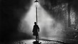© FANTASY WORLD - A black-and-white image of a silhouetted figure walking into a beam of light under an old streetlamp.