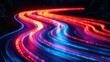 © Lemdah - Abstract light trails on a winding road at night.