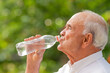 © carballo - senior man drinking water from bottle