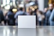 © Roman - Minimalistic blank card stands out against blurred crowd, emphas