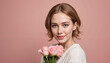 © Alina - Smiling woman holding pink roses against pastel background
