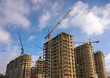 © Rafail - Construction cranes working on new residential complex in Moscow, bright blue sky