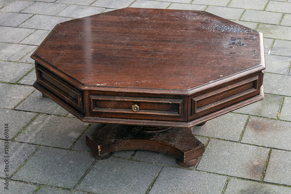 brown polygonal wooden coffee table stands outside on the street