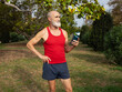 © Westend61 - Senior man standing with water bottle in park on sunny day
