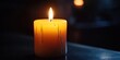 © Chanrothana Pech - A lit candle in a dark room, symbolizing mourning and honoring someone's memory.