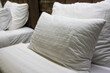 © Dontree - Soft white pillows arranged on a bed, perfect for relaxation