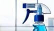 © swan - Close-up of a blue spray bottle, clean and ready to use.