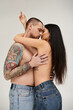 © LIGHTFIELD STUDIOS - A seductive couple shares an intimate kiss in a studio setting, embracing the spirit of romance.