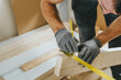 © lithiumphoto - Close up of carpenter measuring wooden board using tools in his workshop