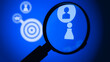 © Caroline - Closeup of magnifying glass with target and person icons on blue background, symbolizing horizon for potential new customer or employee. AI