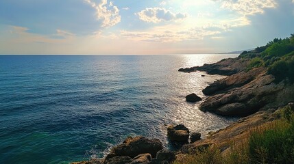 Wall Mural - Serene Coastline at Sunset with Calm Waters and Rocky Shoreline Surrounded by Lush Greenery and Scenic Landscape