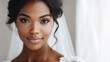 © AbstractAI - Elegant bridal portrait of a black female bride in white wedding dress with natural makeup and soft hairstyle looking directly at camera