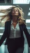 © Olga - Confident female executive in power pose with dramatic office lighting