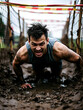 © Jonathan - Determined Man Crawling Through Mud During Obstacle Course