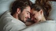 © Alex Pios - couple cuddling in bed, wrapped in soft blankets