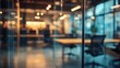 © El Media - A modern office interior showcases glass walls and a blurred view of a professional workspace, featuring sleek conference tables and ergonomic chairs in a well-lit environment.
